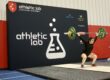 woman lifting a barbell above her head